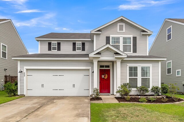 view of front of house with a garage and a front lawn