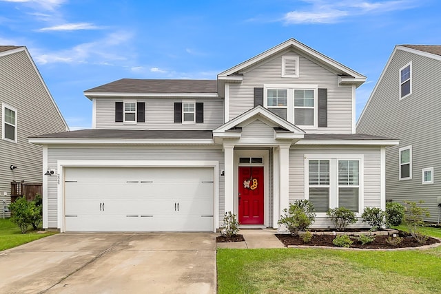 view of front of property with a garage and a front yard