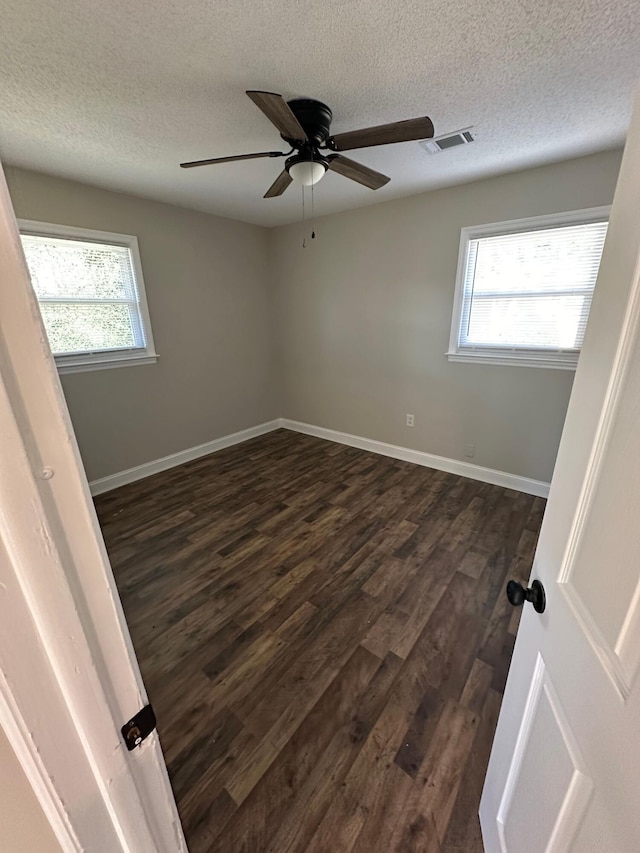 1516 N Avalon Cir, Charleston, SC 29407 - empty room with dark wood-style flooring, a textured ceiling, plenty of natural light, ceiling fan, and baseboards