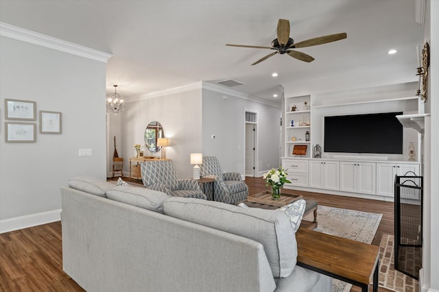 living room featuring ornamental molding, ceiling fan with notable chandelier, built in shelves, and dark wood-type flooring