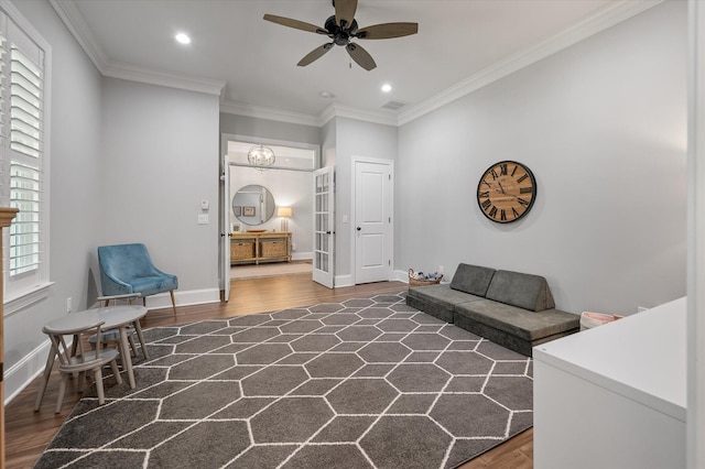 sitting room featuring dark hardwood / wood-style floors, ceiling fan, and ornamental molding