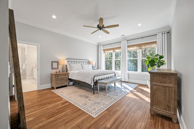 bedroom featuring ensuite bath, ceiling fan, crown molding, and hardwood / wood-style floors