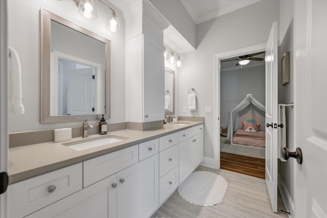 bathroom with tile patterned floors, ceiling fan, vanity, and ornamental molding