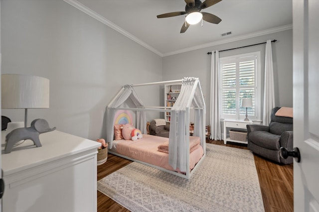 bedroom featuring ceiling fan, dark hardwood / wood-style flooring, and ornamental molding