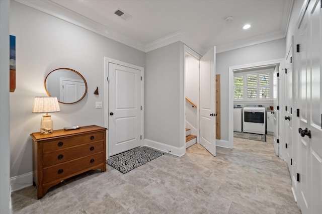 entryway with washer and clothes dryer and crown molding