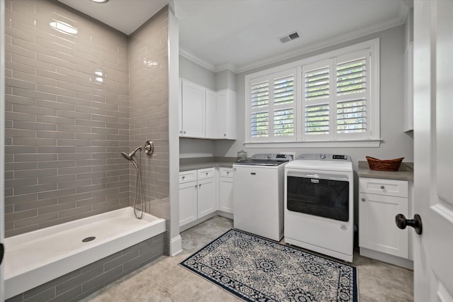 laundry room featuring crown molding, light tile patterned floors, and washer and dryer