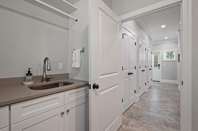 bathroom with vanity and ornamental molding