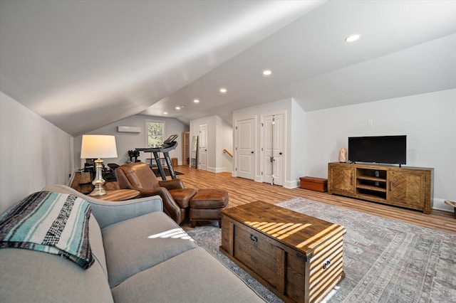 living room featuring light hardwood / wood-style floors and lofted ceiling