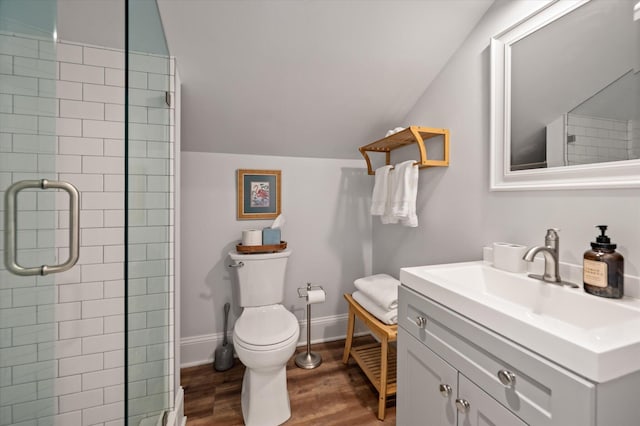 bathroom with walk in shower, vanity, hardwood / wood-style floors, toilet, and lofted ceiling