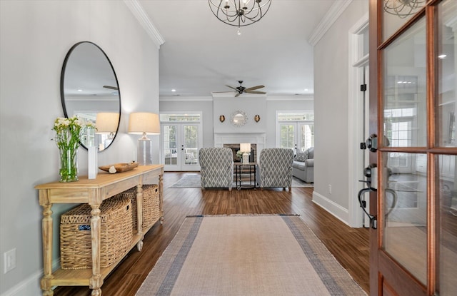 entrance foyer with a wealth of natural light, crown molding, and french doors