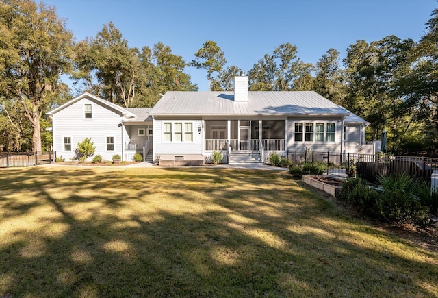 back of property featuring a yard and a sunroom