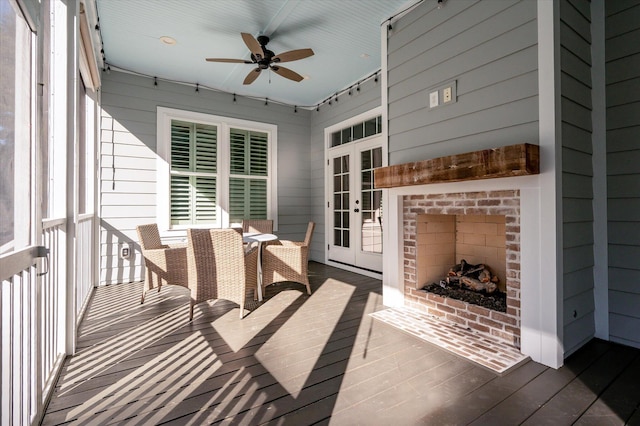 exterior space featuring an outdoor brick fireplace and ceiling fan