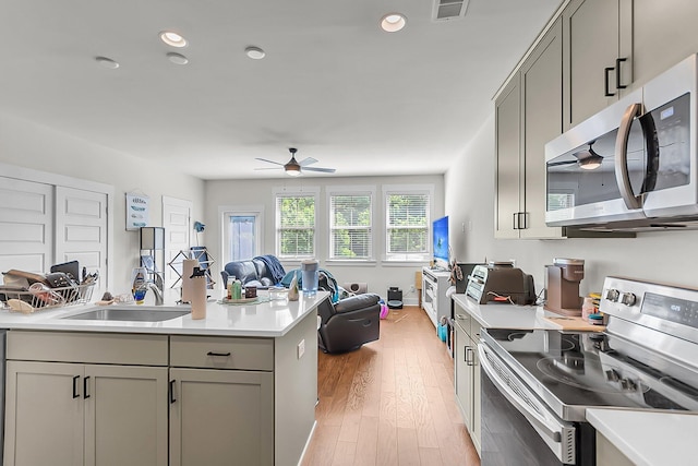 7812 Park Gate Dr, North Charleston, SC 29418 - kitchen with stainless steel appliances, open floor plan, gray cabinets, ceiling fan, and light countertops