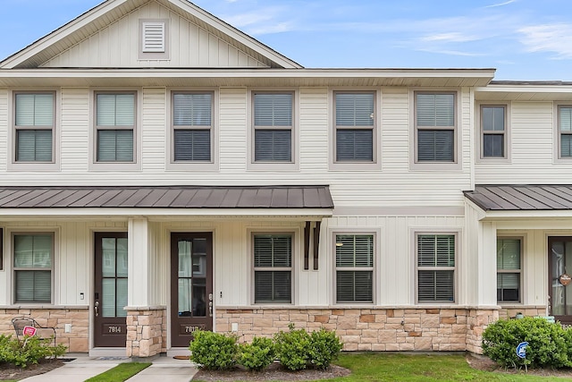7812 Park Gate Dr, North Charleston, SC 29418 - view of property featuring stone siding, a standing seam roof, metal roof, and covered porch