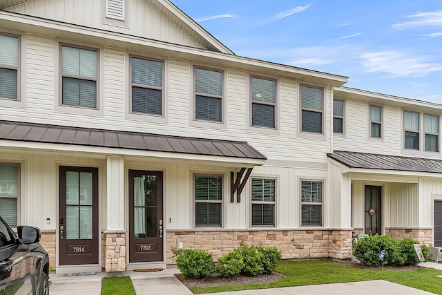 7812 Park Gate Dr, North Charleston, SC 29418 - view of property featuring a standing seam roof, board and batten siding, metal roof, and stone siding