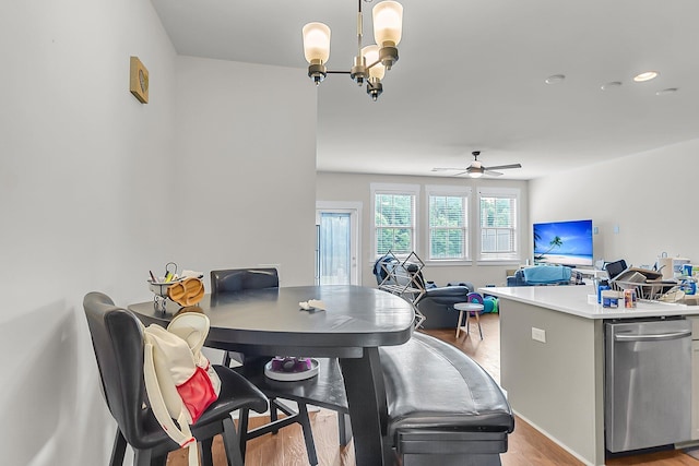 7812 Park Gate Dr, North Charleston, SC 29418 - dining room with light wood-type flooring, a ceiling fan, and a chandelier