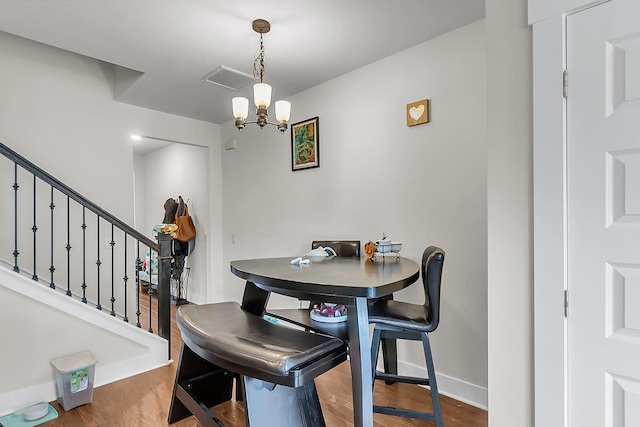7812 Park Gate Dr, North Charleston, SC 29418 - dining space with a chandelier, baseboards, wood finished floors, and stairs