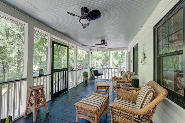 sunroom featuring a ceiling fan and healthy amount of natural light