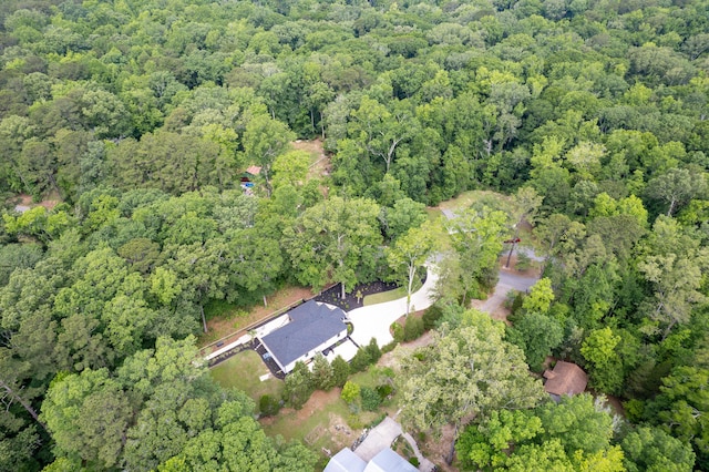 aerial view of property's location with a heavily wooded area
