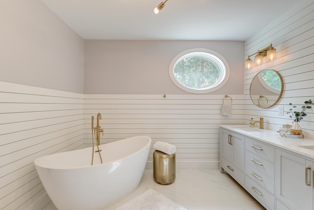 bathroom with a soaking tub, double vanity, wooden walls, and marble look tile flooring
