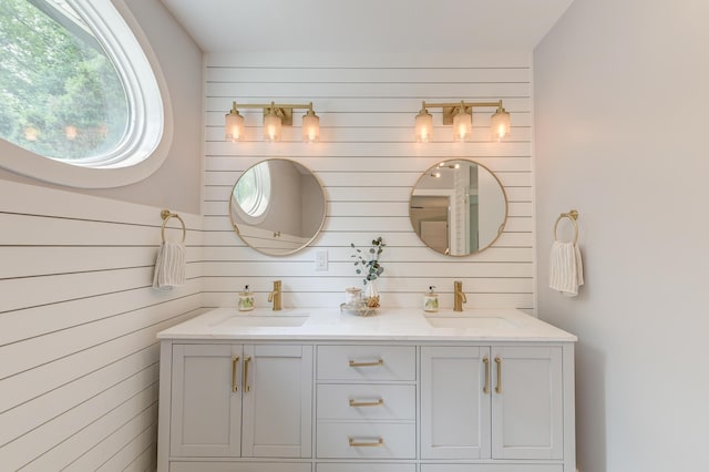 bathroom with double vanity and wooden walls