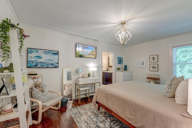 bedroom with dark wood-style floors, a chandelier, and connected bathroom