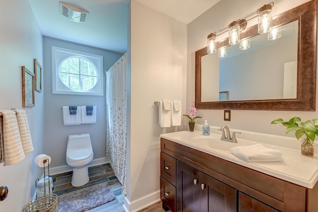 full bathroom with toilet, vanity, wood finished floors, baseboards, and curtained shower
