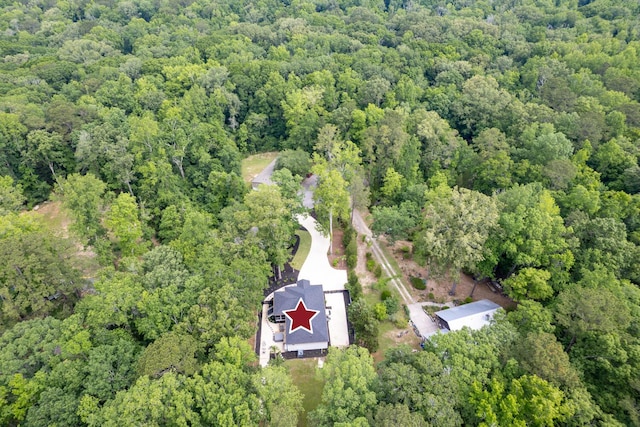 aerial view of property's location featuring a heavily wooded area