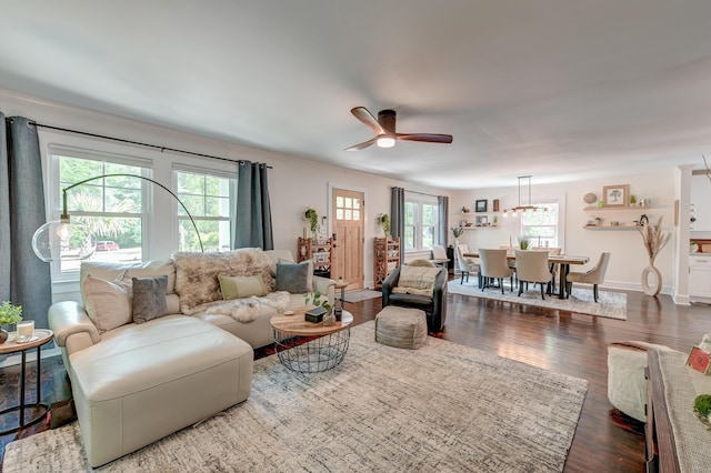 living room with wood finished floors, a ceiling fan, and baseboards