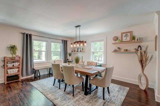 dining area with plenty of natural light, dark wood-type flooring, baseboards, and crown molding
