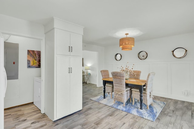 dining area featuring electric panel and light hardwood / wood-style floors