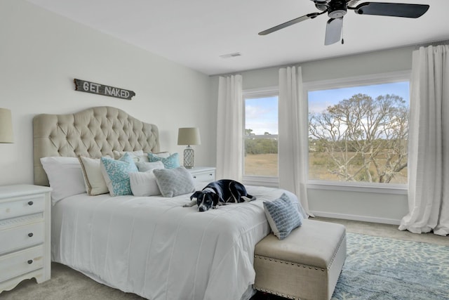 bedroom with ceiling fan and light colored carpet