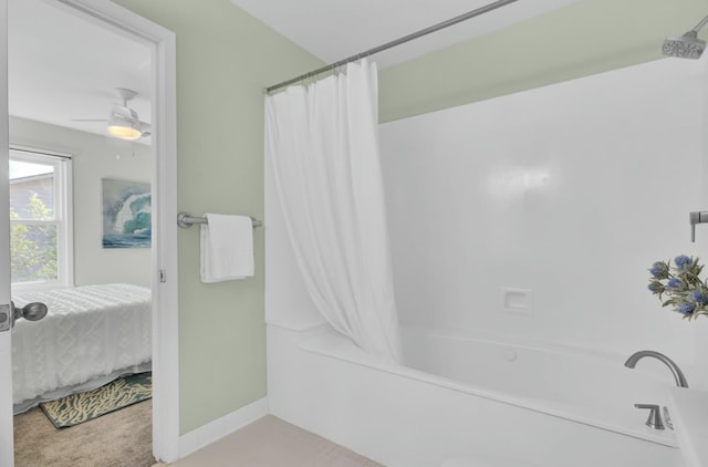 bathroom featuring ceiling fan and shower / bath combination with curtain