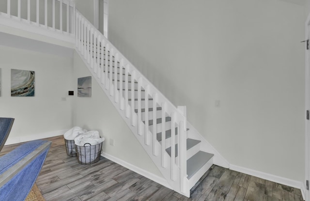 stairway featuring wood-type flooring