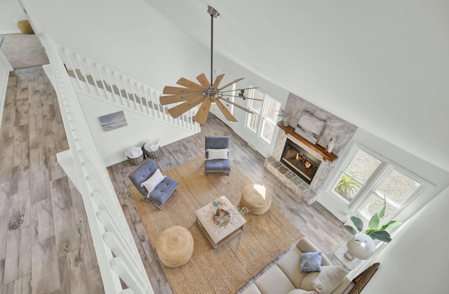 living room with hardwood / wood-style flooring, high vaulted ceiling, and ceiling fan