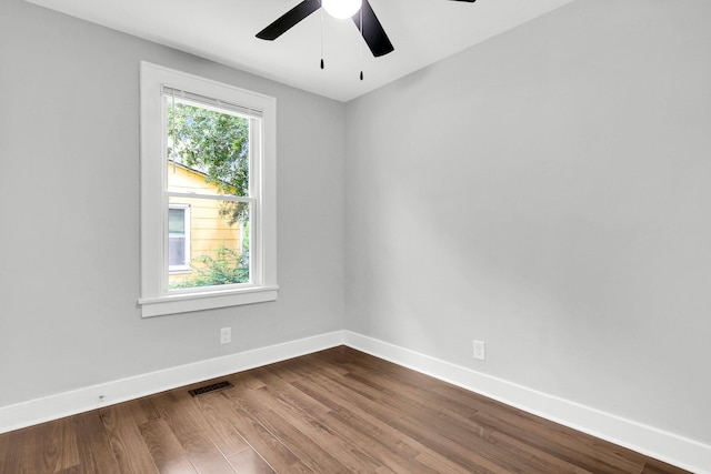 empty room with hardwood / wood-style floors and ceiling fan