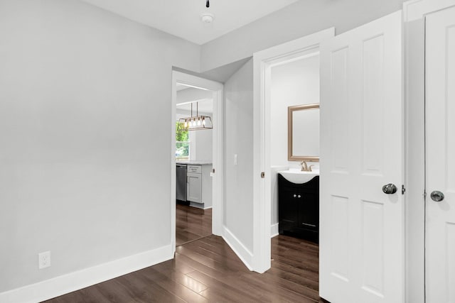 hallway with dark wood-type flooring and sink