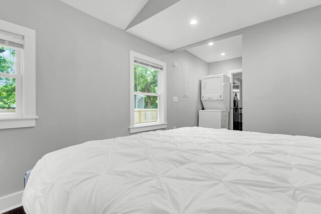 bedroom featuring dark hardwood / wood-style floors, connected bathroom, and lofted ceiling