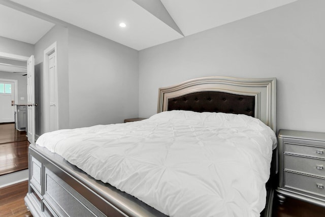 bedroom featuring wood-type flooring and vaulted ceiling