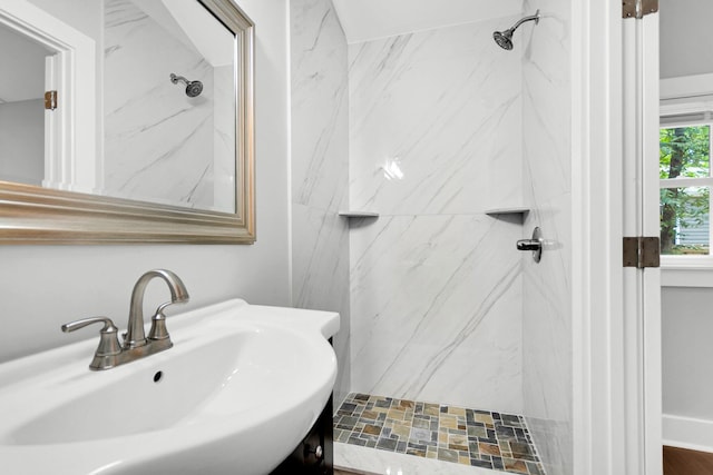 bathroom featuring sink and a tile shower