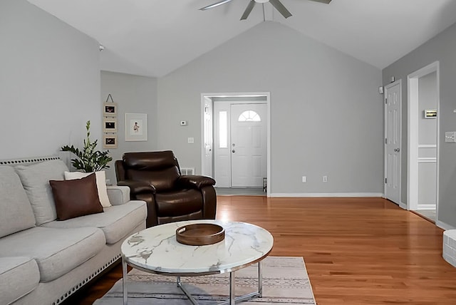 living room with wood-type flooring, lofted ceiling, and ceiling fan