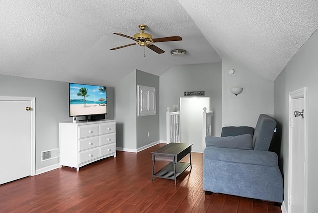 living room with lofted ceiling, dark hardwood / wood-style floors, a textured ceiling, and ceiling fan