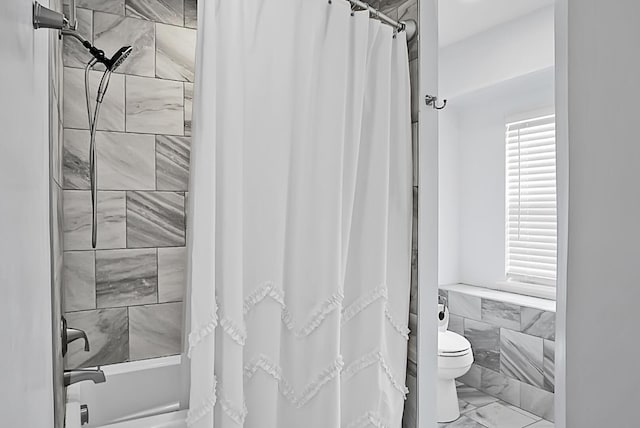 bathroom featuring shower / bath combo with shower curtain and toilet