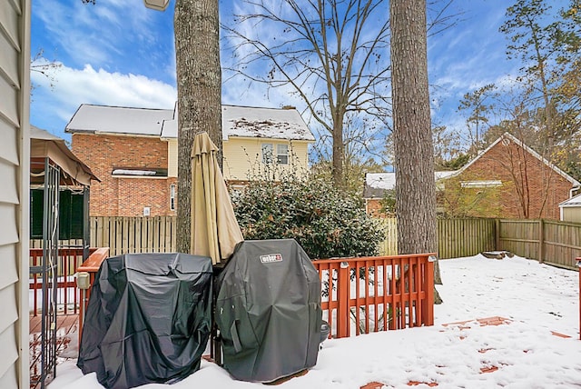 snow covered deck featuring a grill