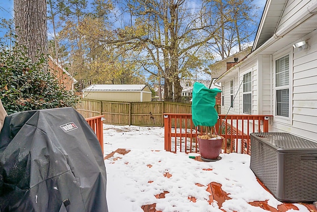 snow covered deck featuring area for grilling