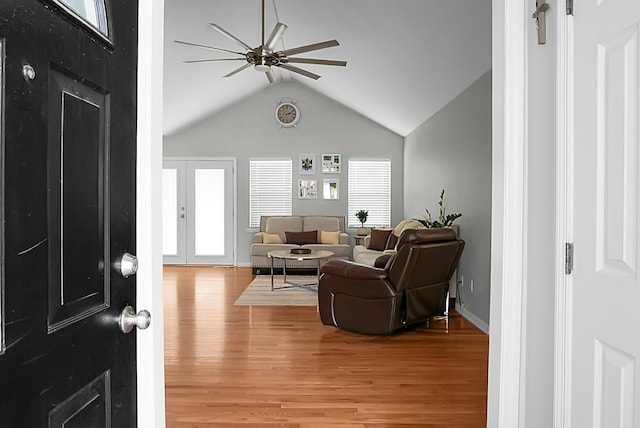 living room featuring hardwood / wood-style floors, french doors, a healthy amount of sunlight, and ceiling fan