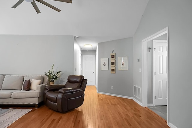 living room featuring wood-type flooring and ceiling fan