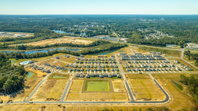 view of property's community featuring a playground, a lawn, and a water view