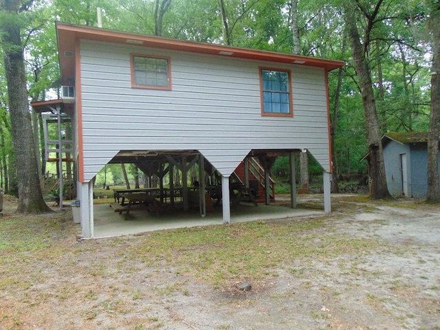 rear view of property featuring a storage shed