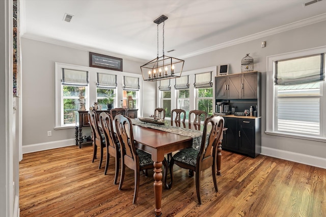 2649 Starfish Dr, Johns Island, SC 29455 - dining area with ornamental molding, a chandelier, plenty of natural light, baseboards, and wood finished floors